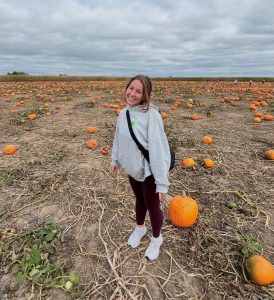 person in a pumpkin patch