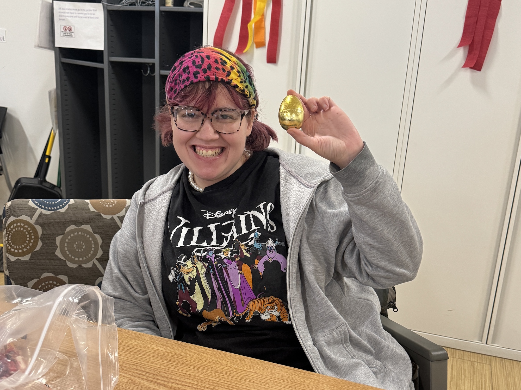 Emma Doty holds up a golden egg for the camera.