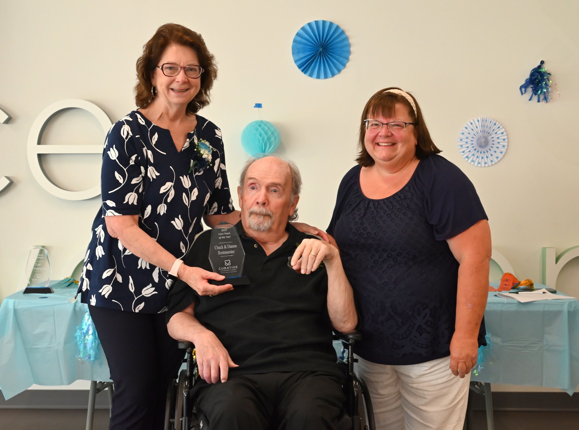 Diane, Chuck, and Valarie pose for the camera to commemorate an award they received.