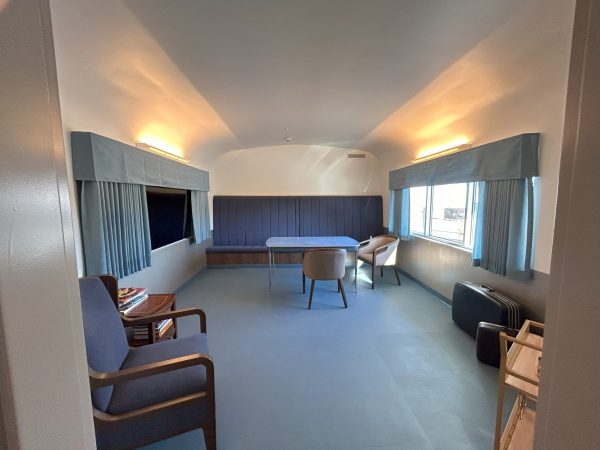 The inside of the train car with the window and the seat